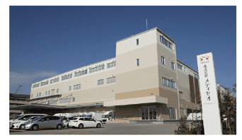 A large building with cars parked in front of it.